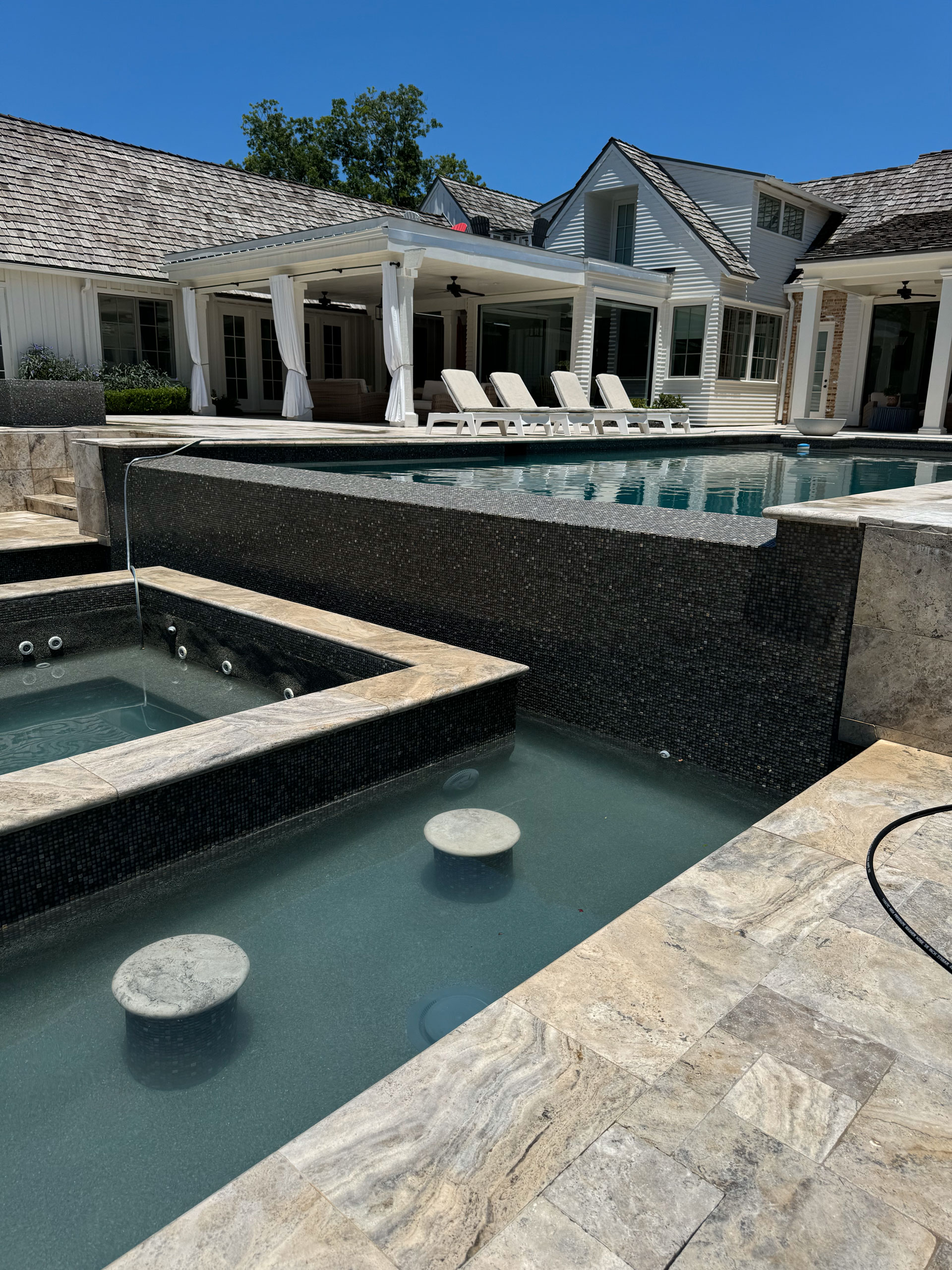 Backyard oasis after tile cleaning by Sundance Pool Services.